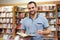 Portrait of a man with glasses in a bookstore