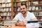 Portrait of a man with glasses in a bookstore