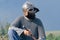 Portrait of a man in medieval clothes on a summer field. Viking armor. Metal helmet and chain mail. Close-up