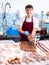 Portrait of man offering fresh fish flounder at seafood shop