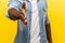 Portrait of man offering hand to handshake, getting to know new people. studio shot isolated on yellow background