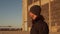 Portrait of a man over industrial buildings and sunset background.