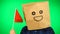Portrait of man with paper bag on head waving Moroccan flag with smiling face against green background.