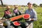 Portrait of man plantation worker with two halves of ripe watermelon