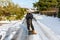 Portrait of a man preparing to clear a snow covered road with a snow shovel. Winter safety, clearing snow and ice concept