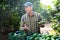 Portrait of man professional farmer during harvesting of avocado at plantation