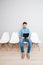 Portrait of man sitting on chair and reading his resume in folder