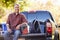 Portrait Of Man Sitting In Pick Up Truck On Camping Holiday