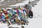 Portrait of man in the snow taking photo against multicolor praying flags