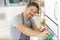 portrait man spraying product to clean oven