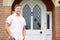 Portrait Of Man Standing Outside Front Door Of Home