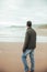 Portrait of man in stones at Oyambre beach in Cantabria, north of Spain