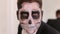 Portrait of man in suit with Halloween skull make-up showing his emotions.