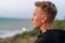 Portrait of a man at sunset near sea, profile of a attractive face