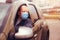 Portrait of a man with a surgical mask on his face in a car