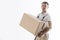 Portrait of man in uniform with cardboard box isolated on white background. Relocation service. Loader holds box