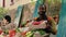 Portrait of man vendor selling box filled with bio tomatoes