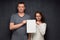 Portrait of man and woman holding blank paper sheet together