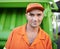 Portrait, man and working with garbage truck for trash, outdoor and Cape Town. Male person, adult and employee with