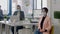 Portrait of manager with face mask sitting on chair at desk table