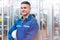 Portrait of manual man worker is standing with confident with blue working suite dress and safety helmet in front the glass wall