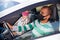 Portrait of married couple in protective masks in car