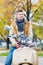 Portrait of mature attractive man sitting on motor bike while waiting in park