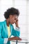 Portrait of mature black unhappy business woman at desk in office