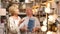 Portrait of mature couple choosing table lamp at store of household goods
