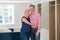 Portrait Of Mature Couple At Home As New Luxury Kitchen Is Fitted