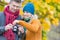 Portrait of mature couple looking pictures on camera in park