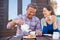 Portrait Of Mature Couple Sitting On Bench In Cafe Whilst Visiting Garden Center