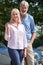 Portrait Of Mature Couple Standing Next To Classic Open Top Sports Car