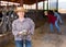 Portrait of mature farm owner in cowshed