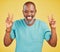 Portrait of a mature friendly african american man looking happy and smiling while making an peace gesture with both his