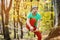 Portrait of a mature male highliner doing slackline balance training in the forest in autumn