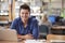 Portrait Of Mature Male Student Using Laptop In Library