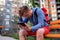 Portrait of mature man in casual clothing using digital tablet outdoors.