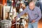 Portrait of mature man choosing vintage goods at antiques shop