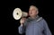 Portrait of a mature man protesting shouting through a megaphone