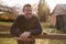 Portrait Of Mature Man Repairing Garden Fence