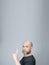 Portrait of mature man standing on white background. Bald bearded man making gestures