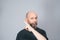 Portrait of mature man standing on white background. Bald bearded man making gestures