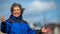 Portrait of a mature Mexican woman with arms outstretched and her hair disheveled by the wind