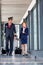Portrait of mature pilot walking with young attractive stewardess in airport