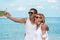Portrait of mature smiling couple taking a selfie at the beach