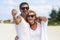 Portrait of mature smiling couple taking a selfie at the beach