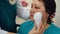 Portrait mature woman receiving face massage with massager in cosmetology clinic