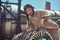 Portrait of a mechanic in uniform and flying helmet, repairing the dismantled airplane turbine in an open-air museum.