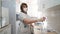 Portrait of medical laboratory technician in respirator and pipette with bulb